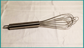 A stainless steel whisk